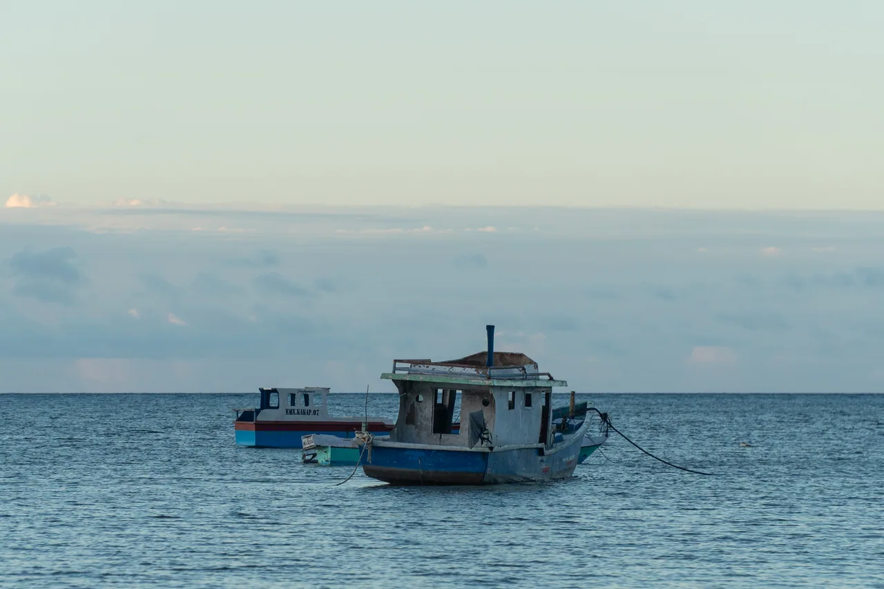 A fishing boat on calm blue water at Laipori