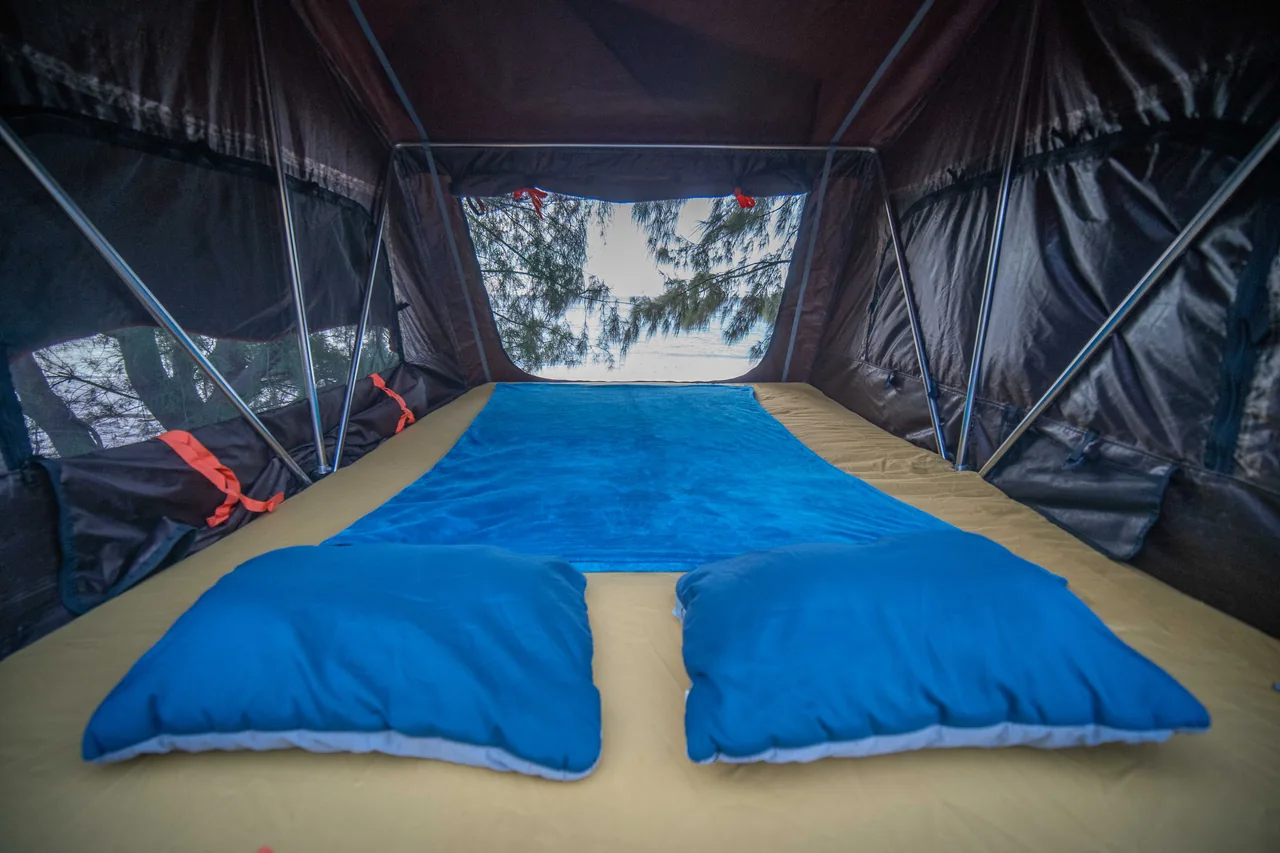 Pillows and bedding inside the Jeep rooftop tent